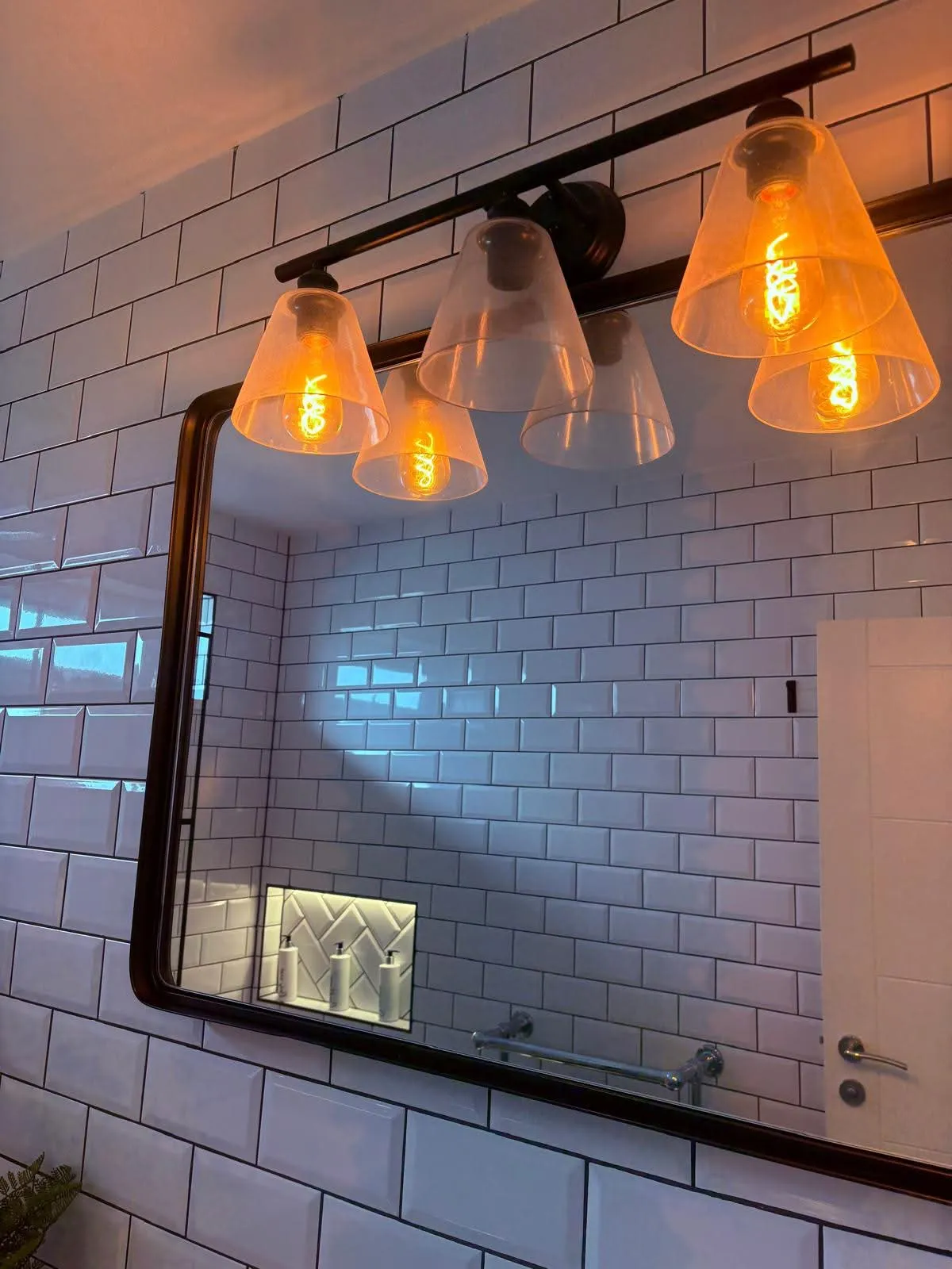 Gleaming bathroom mirror and lighting after a clean