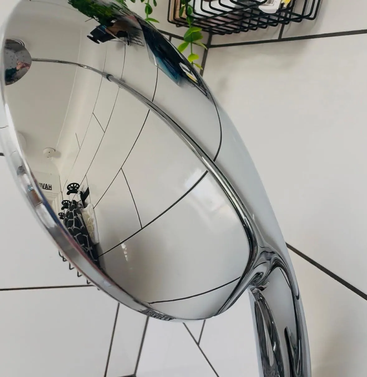 Polished bathroom mirror reflecting a tidy space