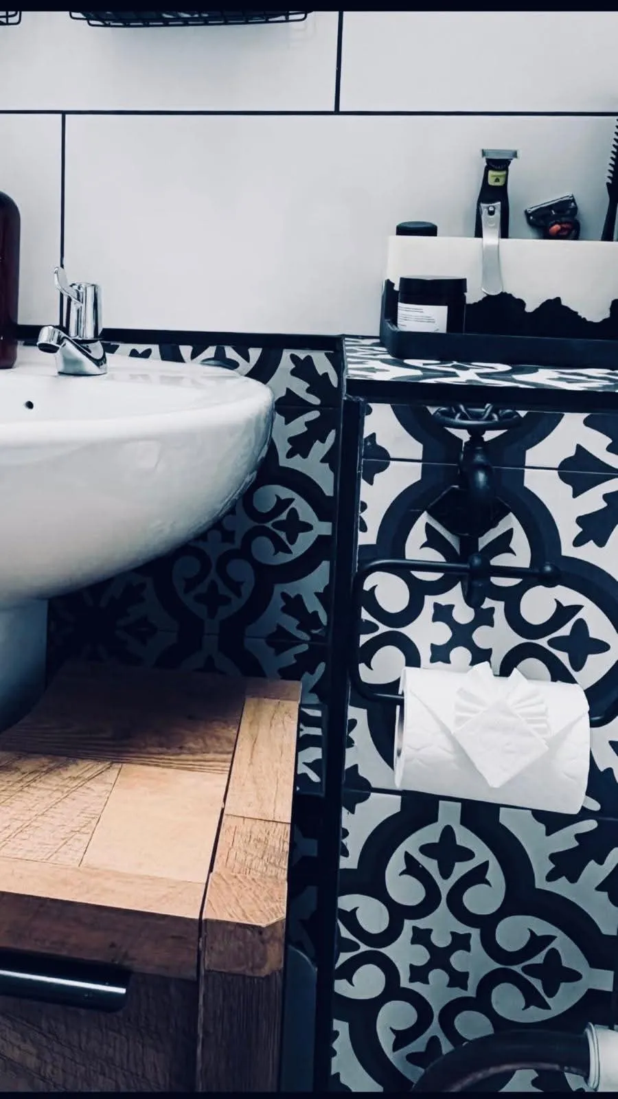 Spotless bathroom with patterned black and white tiles